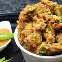 Mix Pakora · Spinach, potatoes, onions and cauliflower coated with gram batter and deep fried.