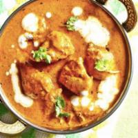 Butter Chicken · Boneless chicken cooked in onion, tomato, butter and creamy spiced curry sauce.
