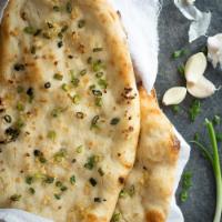 Garlic Nan · All purpose flour flat bread baked in tandoor topped with garlic, coriander and butter.