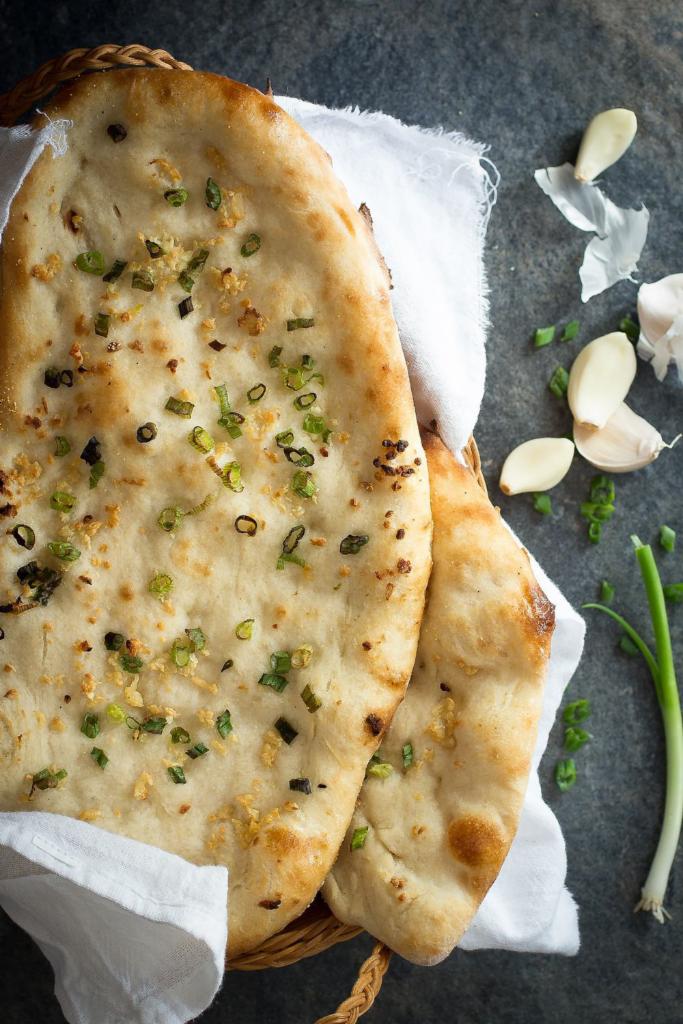 Garlic Nan · All purpose flour flat bread baked in tandoor topped with garlic, coriander and butter.