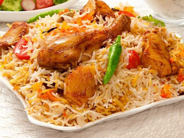 Chicken Biryani · Aromatic basmati rice dum-style cooked with chicken, spices and nuts flavored with saffron.