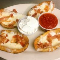 Potato Skins · Crispy potato skins served with cheese, bacon, sour cream and salsa. 4 to an order. 