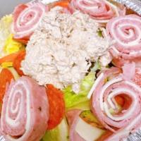 Antipasto Salad · Lettuce topped with cucumbers, tomatoes, red onions, olives, Genoa salami, cooked salami, ha...