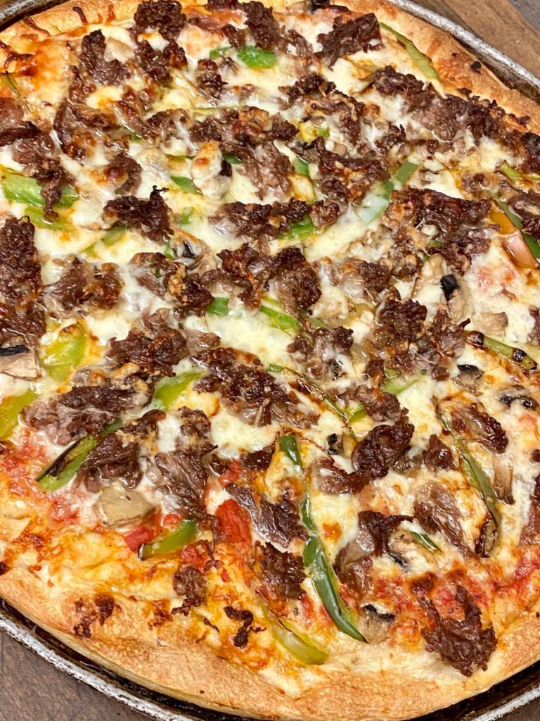 Cheese Steak Pizza · Our homemade pizza with grilled Delmonico steak, onions, green peppers and mushrooms.