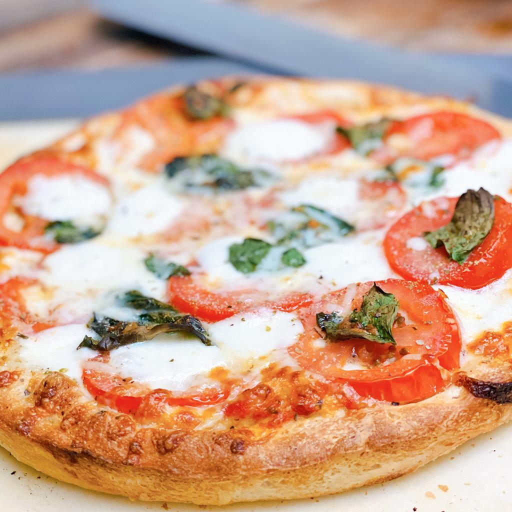 Tony's Margherita · Our traditional pizza (sauce and blended cheeses) topped with fresh sliced tomatoes, mozzarella and basil, sprinkled with garlic and oregano
