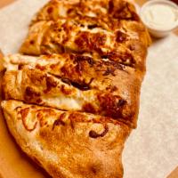 BBQ Chicken Calzone · Made with our homemade dough, folded over and stuffed with fresh ingredients (BBQ chicken an...
