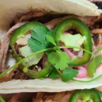 Pork Taco · Smoked local duroc pork with pickled onions, cilantro, and fresh jalapenos.