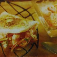 Arepa con Camarones · Arepa grilled filled with shrimp in Creole sauce.