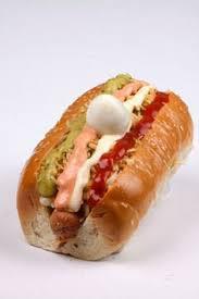 Super Perro · Hotdog, cheese, crushed (potato chips), bacon, pineapple syrup, quail eggs, pink, tartar, ga...