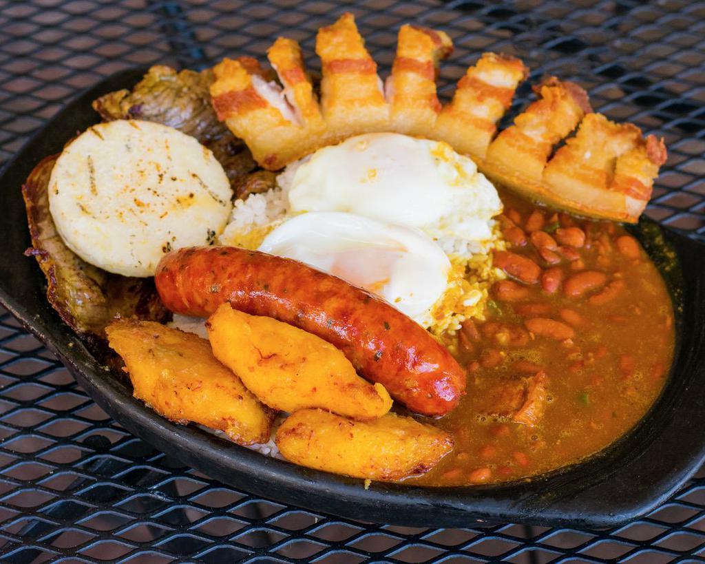 Bandeja Paisa · Red beans, rice, fried pork belly, sausage, grill steak, fried egg sunny up, avocado, sweet plantains and small arepa.