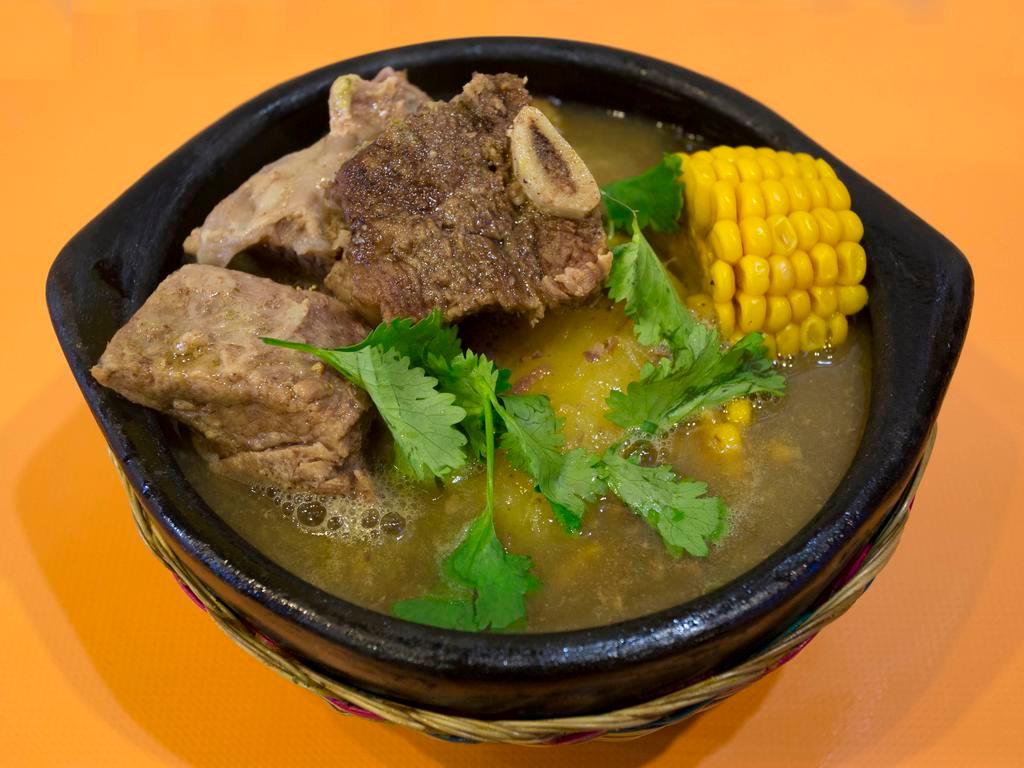 Sancocho de Costilla · Beef broth served with rice, potatoes, cassava and avocado.