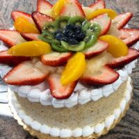Passion Fruit Cake · Vanilla cake filled with fresh strawberries, kiwi, pineapple, peaches, and strawberry mousse...