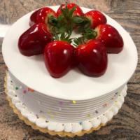 Atomic Cake · 4 layer cake. Vanilla, chocolate, cheesecake, and fresh strawberries whipped cream topping a...