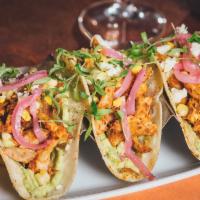 Chicken Tinga Taco · House-smoked pulled chicken, avocado mash, pickled red onion, grilled corn, micro cilantro, ...