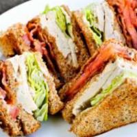 Club Sandwich · 3 layers of roasted turkey, ham, and bacon. Served with cheese, lettuce, and tomatoes on you...