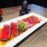 A1. Goma Tuna Tataki · Seared black crusted tuna in house special sauce.