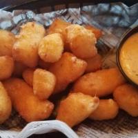 Cheese Curds · Battered white cheddar cheese curds served with our very own spicy Bam sauce.
