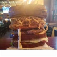 Epic Burger · 1/2 lb beef burger with a breaded mozzarella cheese square and crispy onion straws stacked b...