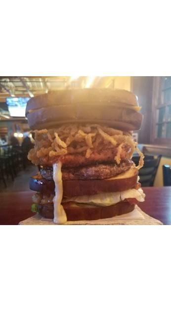 Epic Burger · 1/2 lb beef burger with a breaded mozzarella cheese square and crispy onion straws stacked between a BLT bamwich and grilled cheese bamwich.