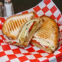 Veggie Panini · Marinated eggplant, artichoke hearts, red roasted peppers and provolone cheese. Lettuce, tom...