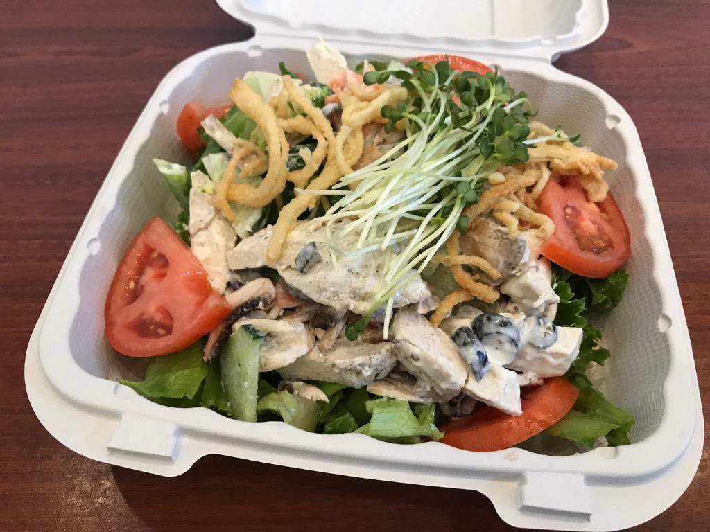 Oriental Chicken Salad · Chicken, broccoli, carrots, olives, mushrooms and cucumbers tossed in a creamy dressing topped with tomatos, kaiware and won ton strips over mesclun.
