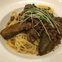 Goma Eggplant and Spicy Ground Beef · Eggplant & spicy ground beef garnished with kaiware sprouts and lemon in a sesame garlic oil...