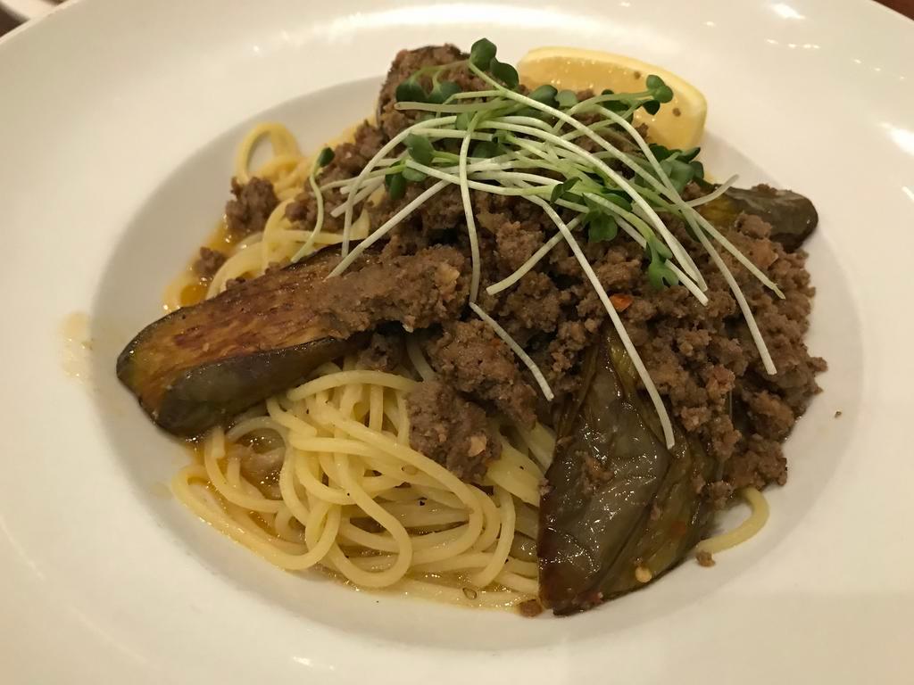 Goma Eggplant and Spicy Ground Beef · Eggplant & spicy ground beef garnished with kaiware sprouts and lemon in a sesame garlic oil sauce with spaghetti pasta. Served with garlic bread.