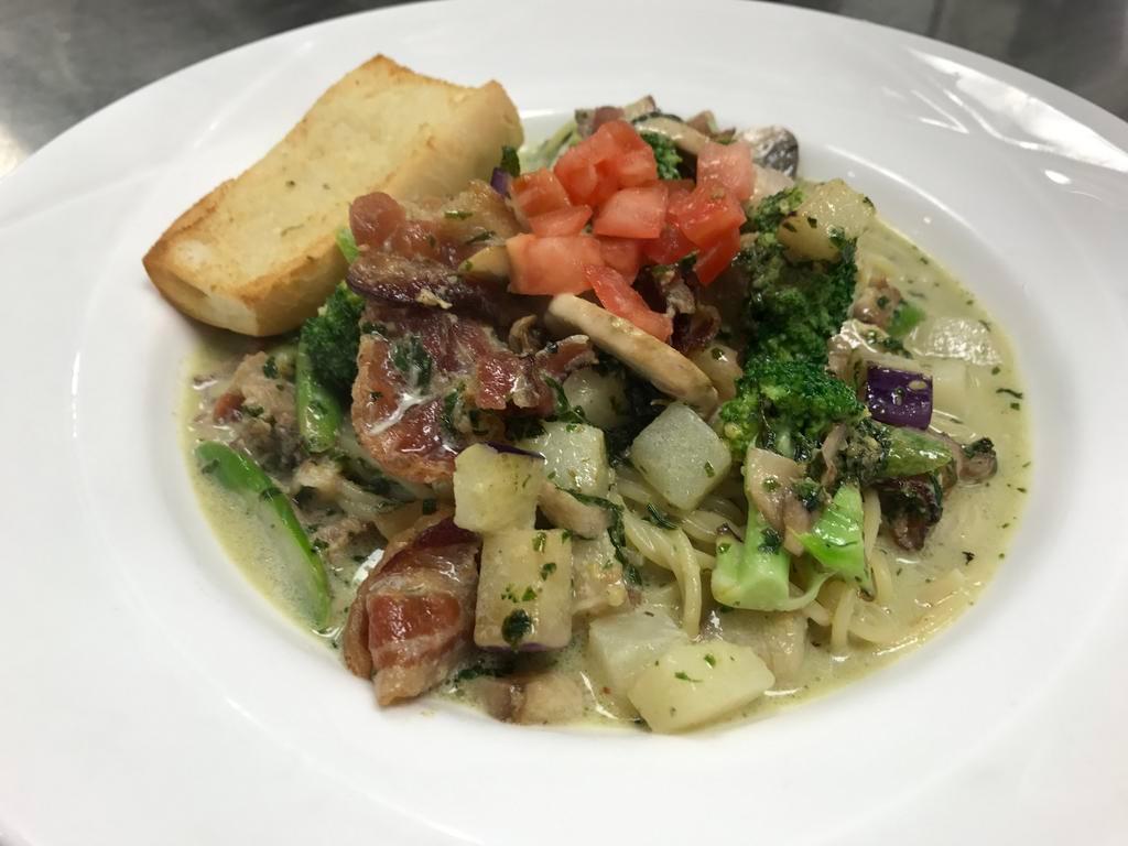 The Original Genovese · Eggplant, mushrooms, broccoli, asparagus, potato, bacon topped with tomato in a basil cream sauce with spaghetti pasta. Served with garlic bread.
