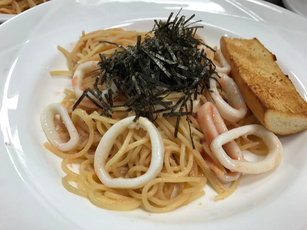 Tarako and Ika · Salted cod fish eggs with ika in a japanese sauce with spaghetti pasta. Served with garlic bread.