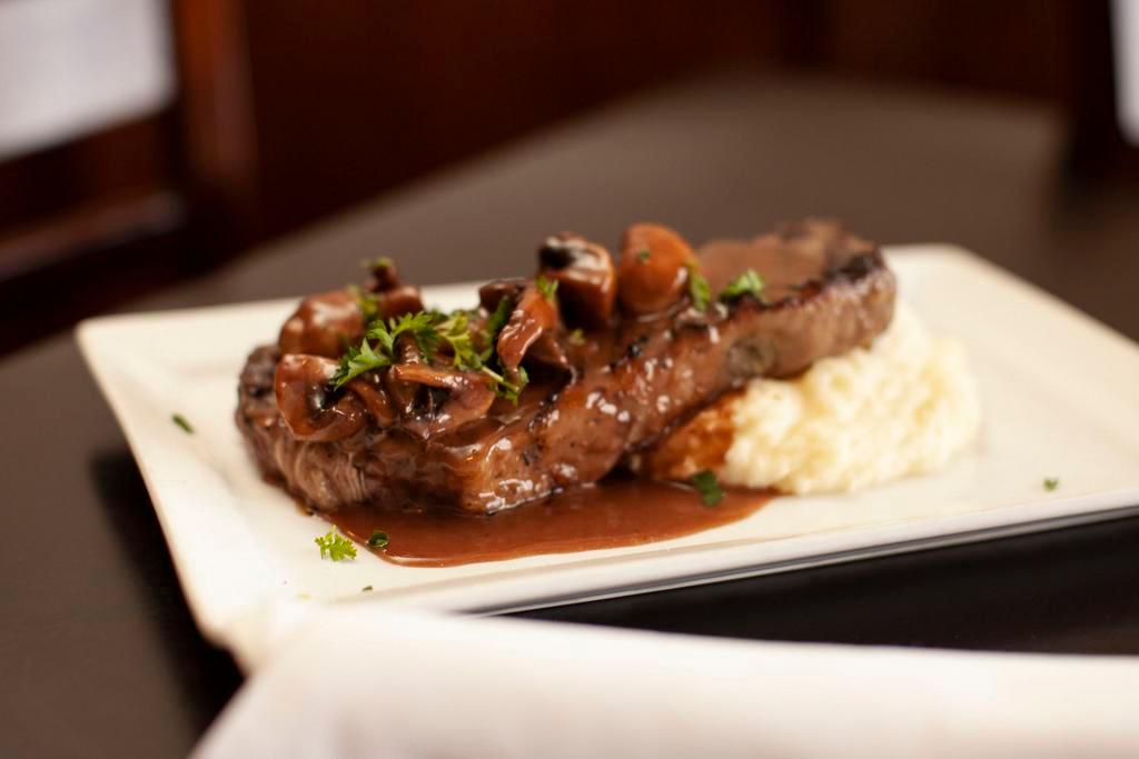 Grilled New York Steak Plate · Garlic mushrooms, red wine reduction and mashed potatoes.