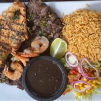 Mar y tierra  · Grilled skirt steak,chicken and  shrimp, tomatoes,  red onion salad with chimichurri sauce.
