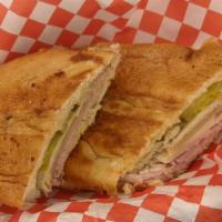 Maru's Cubano Sandwich · Our Cubano Sandwich is made on a roll layered with savory oven roasted pork, sliced ham off ...