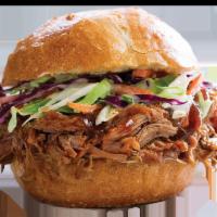 Pulled Pork Sandwich Combo · Savory pulled pork on a Kaiser roll with fresh shredded cabbage and carrots drizzled with BB...