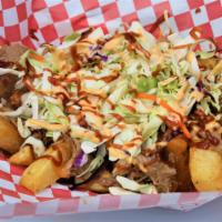 Dirty Yuca Fries · Golden crust yuca fries topped with our savory pulled pork, BBQ Sauce fresh cut cabbage and ...