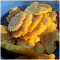 Tostones  · Tostones are double-fried golden crispy salted fried plantain chips, commonly found in latin...