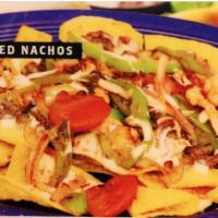 Grilled Nachos · Our cheese nachos topped with choice of grilled chicken or steak cooked with onion, bell pep...