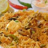 Lamb Biryani · Tender pieces of lamb, cooked in basmati rice, cashew nuts, golden raisins, and exotic spices.