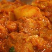 Chicken Vindaloo · Boneless chicken cooked in a tangy sauce with cubed potatoes.