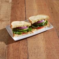 Veggie Sandwich · Garden mix, onions, tomatoes, avocado, cucumber, hummus and tomato aioli on wheat bread.
