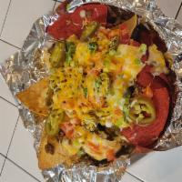 Beef nachos  · Beef, tomatoes, green onions, jalepenos, cheddar cheese and cheese sauce.  Served with Salsa...