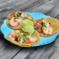 3 Tequila-Lime Shrimp Tacos · Grilled shrimp cooked with seasonings, lime and tequila topped with tomatoes, onions and cil...