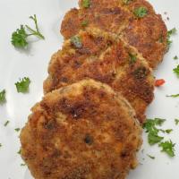 My Mom’s Salmon Patties · (3) salmon Patty cakes, fried to perfection comes with yellow wild rice and beans with lemon...