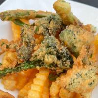 French Fried Broccoli · Fresh broccoli battered and fried topped on golden fries served with our wild ranch dressing.