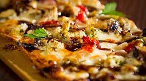 Tuscan Chicken Flatbread · Fresh pesto, caramelized onion, roasted red pepper, and mozzarella cheese
