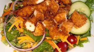 Crispy Chicken Salad · Fresh mixed greens, cucumbers, tomatoes, cheddar cheese and crispy buttermilk chicken strips.