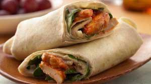 Spicy Chicken Wrap · Crispy chicken tenders, Buffalo sauce, lettuce, tomato, blue cheese dressing and flour torti...