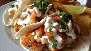 Fish Taco · Parmesan, panko Atlantic cod, shredded cabbage, fresh pico de gallo, zesty white sauce and w...