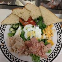 Chef Salad · Butter lettuce, ham, turkey, american and swiss, hard boiled egg, tomato, onion and cucumber.