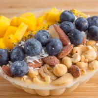 Mango Joy Smoothie Bowl · Blend of mango, papaya, banana, almond butter, almond milk, topped with blueberries, chopped...