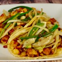 Taco Acorazado · regular tortilla serve with rice choice of mean and topped off with sautéed jalapenos and on...